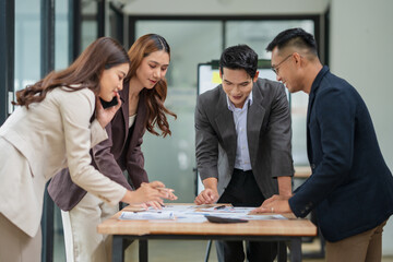 Group of businesspeople are standing in a meeting, exchanging knowledge in the office.
