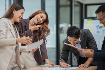 A group of Asian businessmen stood and discussed ways to solve investment business problems.
