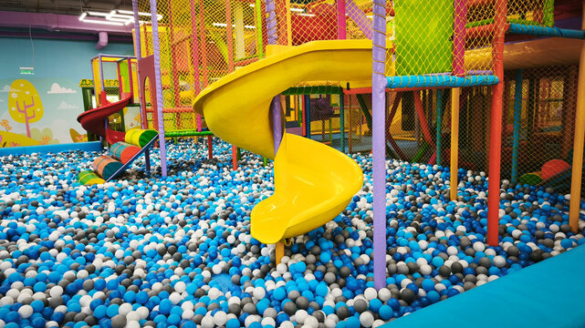 Children's entertainment area, a bright playground with safe climbing frames, colorful obstacles and colorful balls.