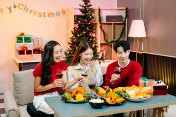 Holiday spirit with Asian friends exchanging gifts, sharing laughs, and enjoying a festive Christmas dinner