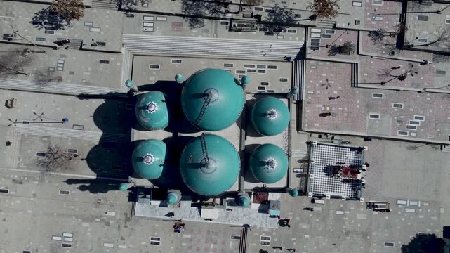 Drone Aerial of Turquoise Sakhi Shrine Blue Mosque, Kabul, Afghanistan. People, Pidgeons and Hillside Homes