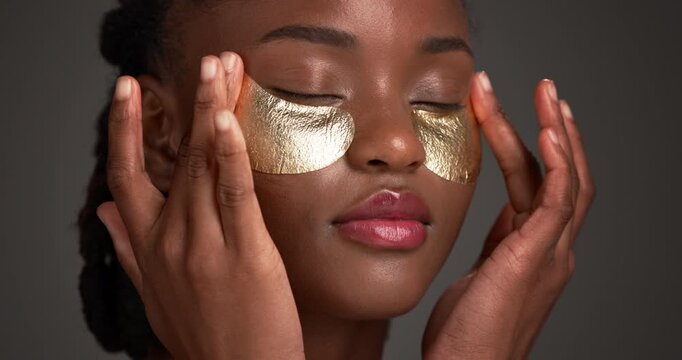 Skincare, gel patch or woman in studio with touch, soothe or hydrate for under eye. Dermatology, antioxidant or black person on gray backdrop with pad, caffeine or hyaluronic acid for puff reduction.