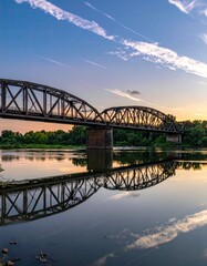 Arched bridge reflected in still water