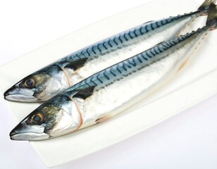 Two whole mackerel on a white plate