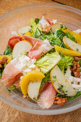 A vibrant salad of crisp lettuce, juicy pears, and prosciutto makes a delightful meal
