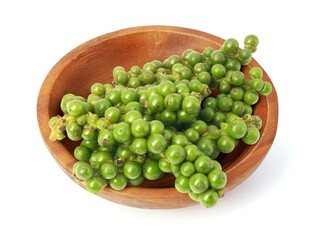 Green peppercorn in wooden bowl isolated on white background