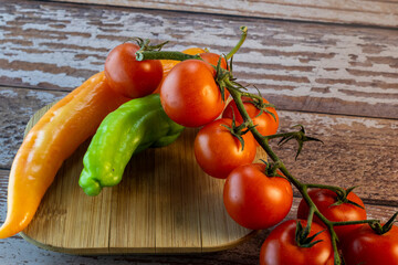 tomatoes and peppers,  fresh tomatoes and peppers on rustic board