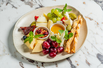 A vibrant spread of fresh fruits and assorted cheeses awaits enjoyment and sharing