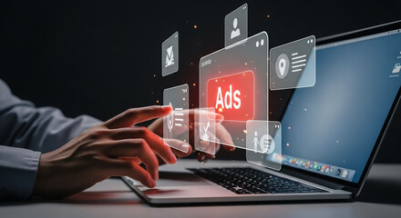 A person's hands interacting with a digital interface displaying advertisements on a laptop screen, representing online advertising and digital marketing strategies.