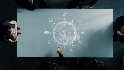 A group of professionals collaborate around a modern table with a digital globe projection, illustrating connectivity, data analysis, and global teamwork in a business environment. Raster - Powered by Adobe
