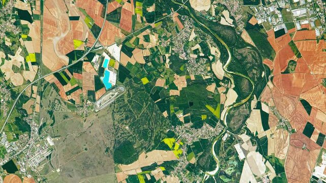 Aerial shot of fertile land and soil, agricultural district. Camera is zooming out, rotating clockwise. Animation based on image by NASA