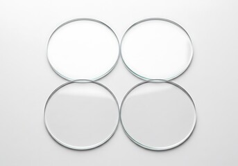 Four round glass lenses isolated on white background for optical concept