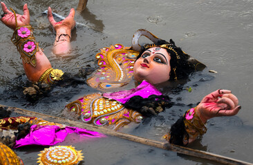 Hindu devotees immerse a clay idol of Goddess Durga into the Brahmaputra River on the concluding day of the Durga Puja festival