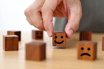 Choosing Happiness Picking Wooden Block with Smiling Face Emotion Concept