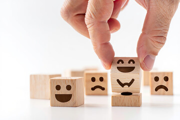Choosing positivity hand selecting happy face wooden block concept