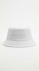 A simple white bucket hat is centered against a plain white background, casting a soft shadow.