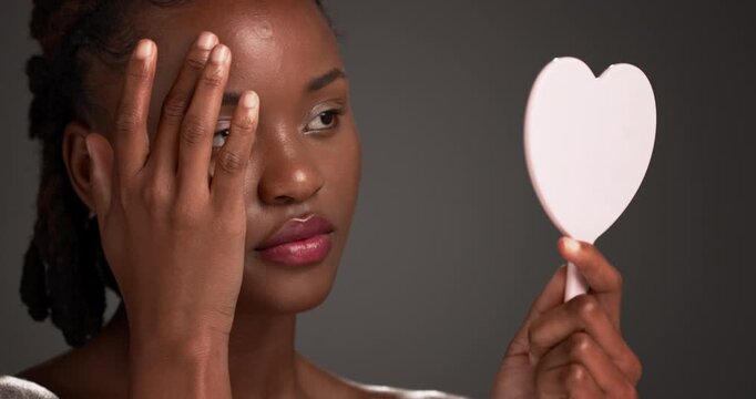 Mirror, black woman and acne patch for skincare, breakout control and skin healing in studio. Cosmetics, beauty and model with spot treatment for pimple, dermatology and face detox on dark background