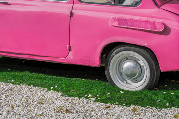 Fragment of an old subcompact car on an autumn day