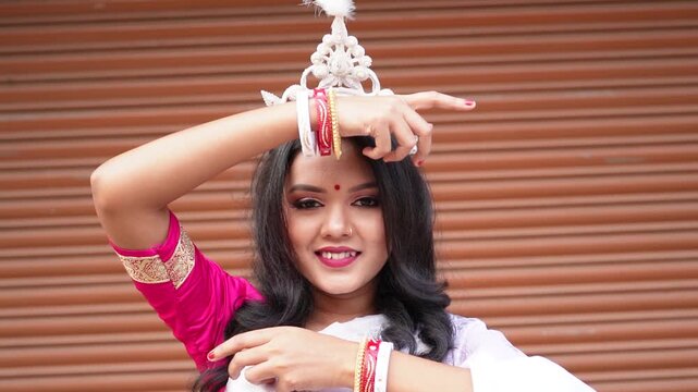 Beautiful Indian bride dressed in Hindu traditional white Saree and golden jewelry. Bengali wedding rituals Briddhi or aibodhi. Bengali woman smiling portrait with briddhi look.