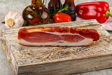 Piece prosciutto crudo over board