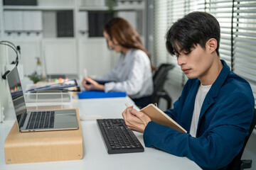 Asian attractive businessman employee working in the office workplace. 
