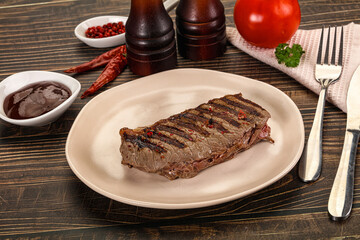 Grilled beef striploin steak with sauce
