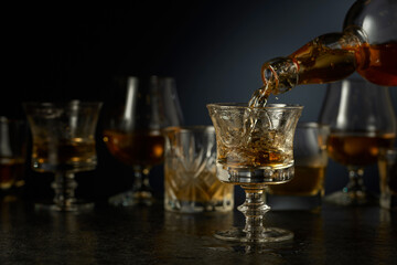 Rum is poured from a bottle into a glass.
