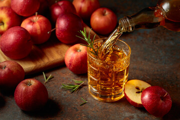 Apple kombucha is poured from a bottle into a glass.