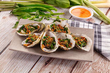 Gournet grilled oysters with onion and peanut