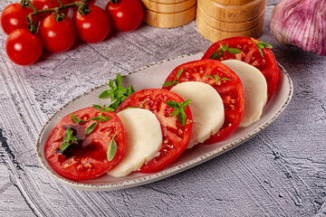 Italian caprese salad with mozzarella, tomato and basil