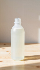 Clear plastic bottle filled with liquid on wooden surface  