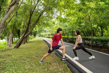 Asian young sport couple exercising together in the morning garden.