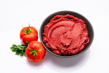 Fresh tomato paste or puree on a white background