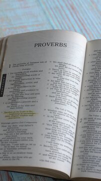 The book of Proverbs of the old testament, Holy Bible. Printed form. High angle, vertical video.