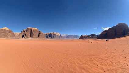 Naklejka premium Red desert vista with rock formations under a clear blue sky