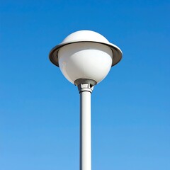 A modern white globe street lamp against a blue sky