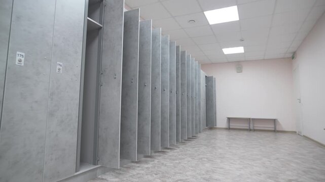 Gym changing room enriched with metallic lockers and open doors. Interior reflects readiness structure along with sports organization