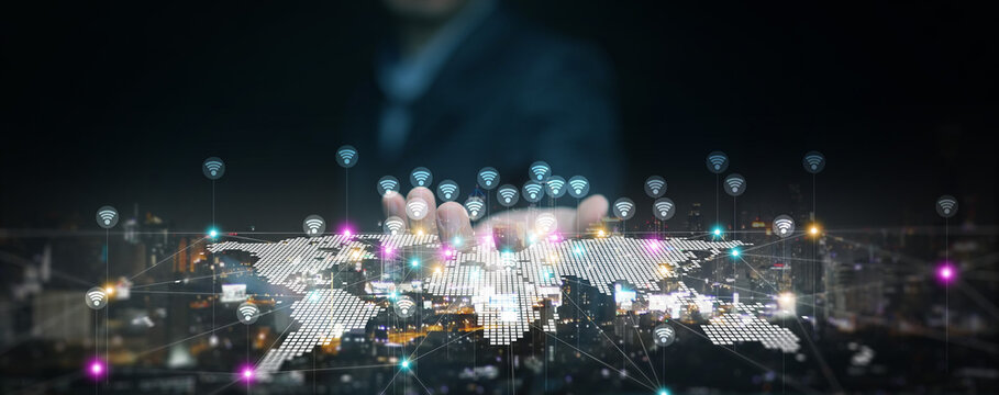 Futuristic concept of human hand connecting global wireless internet with digital world map. WiFi technology, worldwide communication, smart city, connectivity, digital transformation.