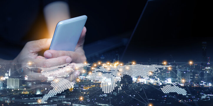 Close-up of businessman using smartphone with digital world map network overlay. Global business, internet technology, modern communication, worldwide connectivity, innovation.