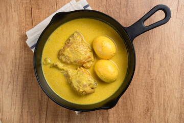 Opor Ayam and egg boiled, Indonesian traditional food served in white bowl, made from chicken cooked with coconut milk and spices. Its served to celebrate Eid Adha and Eid Fitr.