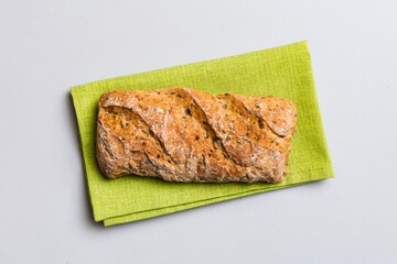 Fresh loaves of bread with wheat and gluten on a colored table. bread on napkin on rustic background, fresh bread top view