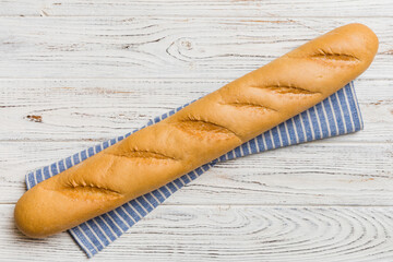 fresh crunchy french baguette on colored table. Top view Bakery products