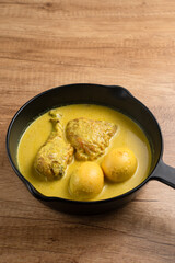 Opor Ayam and egg boiled, Indonesian traditional food served in white bowl, made from chicken cooked with coconut milk and spices. Its served to celebrate Eid Adha and Eid Fitr.