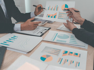 Meeting and discussion of charts and graphs showing the results of successful teamwork, stock...