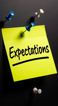 Yellow sticky note with the word expectations written in black marker