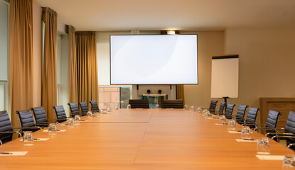 Empty Office Meeting Room with Blank Presentation Screen. Modern Conference Space Setup.