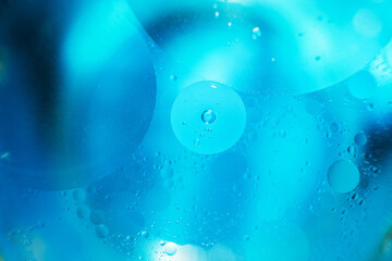 Oil bubbles close up. circles of water macro. abstract light blue background