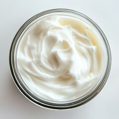Swirled white cream filling a glass jar, top-down view