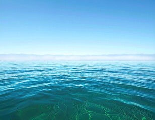 Obraz premium Ocean waves under a clear blue sky