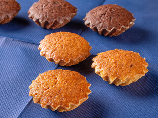 Delicious muffins displayed on a blue napkin background in frontal view